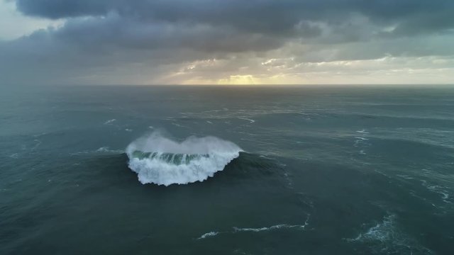 Aerial view on big waves of Atlantic ocean and dramatic sunset sky, 4k