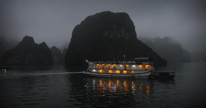 VIETNAM Halong Bay MARCH 18 2019 YEAR, Beautiful scenic view on a foggy cloudy day of the cruises in Halong Bay. It is a beautiful natural wonder in northern Vietnam near the Chinese border, evening