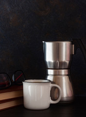 COFFEE CUP WITH COFFEE MIXER WITH BOOKS AND READING GLASSES