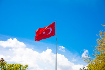 Turkish flag waving at blue sky. Turkey country flag flowing in the wind at blue sky. 