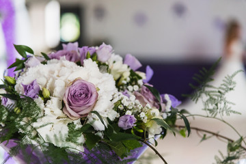 Bouquet of flowers on the table of a reception room of a wedding day