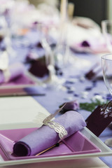 Tables set in the reception hall of a wedding