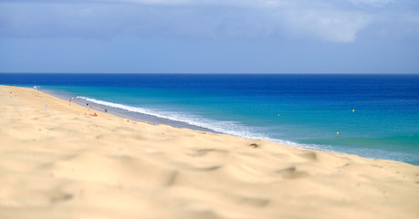Fototapeta na wymiar View from above on beach with golden sand and ocean in Morro Jable, Fuerteventura.