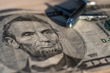 An airplane standing on five dollars. The concept of spending on aviation. The concept of aviation...