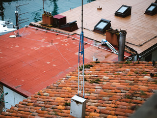 Seagull on top of a building with orange roof tiles