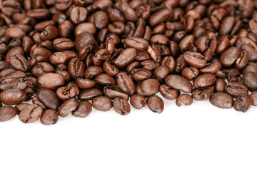 Brown roasted coffee beans, close up, isolated on a white background