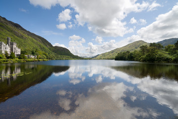 Fototapeta na wymiar Kylemore Abbey in Connemara mountains and reflections in a beautiful lake, County Galway, Ireland