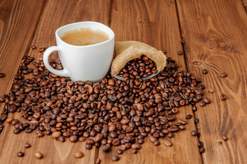 Coffee cup with coffee bag on wooden table. View from top