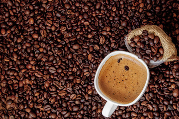 Coffee cup with coffee bag on wooden table. View from top