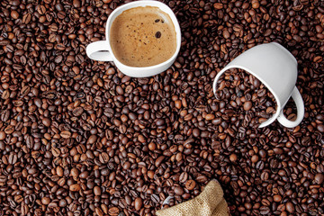 Coffee cup with coffee bag on wooden table. View from top