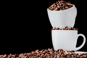 Black coffee in white cup and coffee beans on black background. Top view, space for text