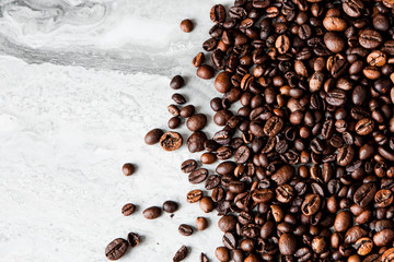 Coffee beans on marble background with copy space for text. Coffee background or texture concept