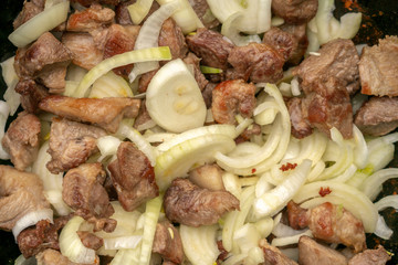 step-by-step process of cooking pilaf in a cast iron cauldron