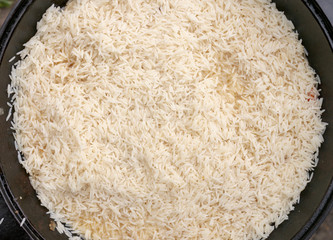 step-by-step process of cooking pilaf in a cast iron cauldron