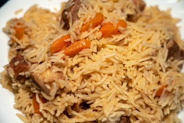 step-by-step process of cooking pilaf in a cast iron cauldron