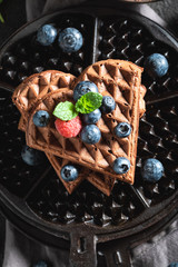 Yummy waffles with dark chocolate and berry fruits