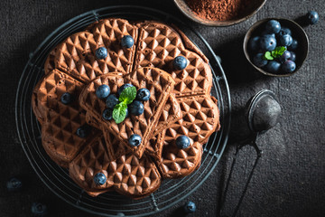 Tasty waffles made of cocoa with fresh berries