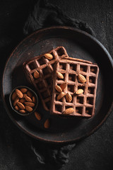 Delicious waffles made of cocoa with nuts