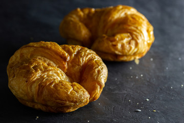 Closeup croissant on table in dark background. Copy space for text.