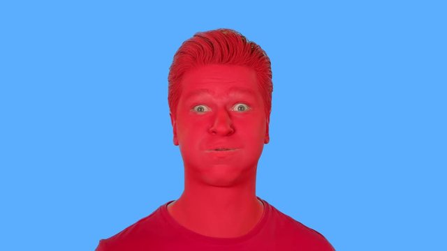 The face of men painted with red paint