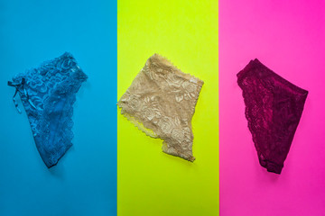 Three women panties on different colored backgrounds. Women underwears