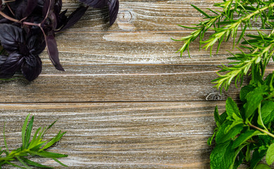 Fresh garden herbs on wooden table. Top view with copy space. Selective focus on the wooden table.