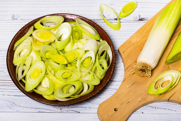 Sliced Leek Green Onion on White Wooden Background. Selective focus.