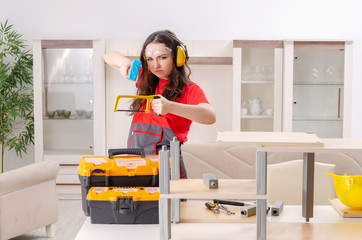 Female contractor repairing furniture at home 