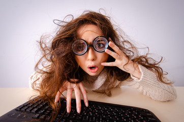 Funny nerd girl working on computer