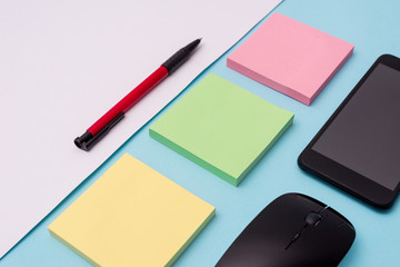 Note papers and stationary plus gadgets placed sideways above backdrop Design business concept Empty template copy space text for Ad website isolated