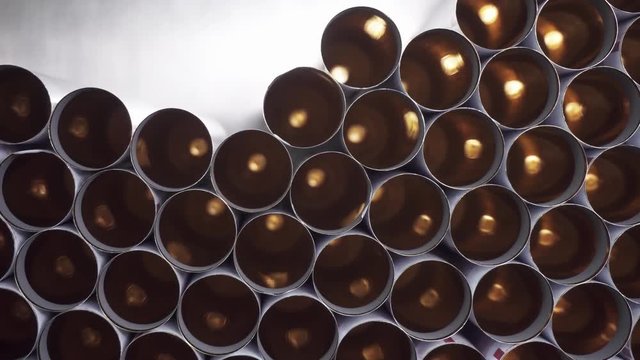 Close-up Tray conveyor vertical feed tubes for the packaging of toothpaste, hair dye, medical preparations. Sterile high-precision modern equipment for the production of medical and cosmetic products
