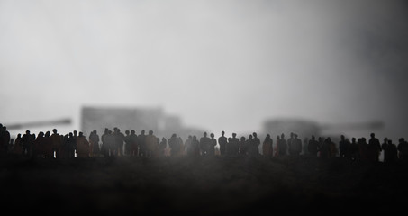 Captured by enemy concept. Military silhouettes and crowd on war fog sky background. World War...