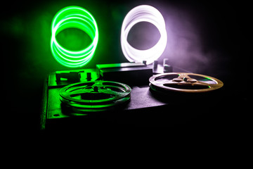 Old vintage reel to reel player and recorder on dark toned foggy background. Analog Stereo Open Reel Tape Deck Recorder Player with Reels.