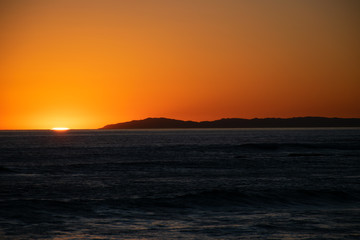 sun setting over ocean