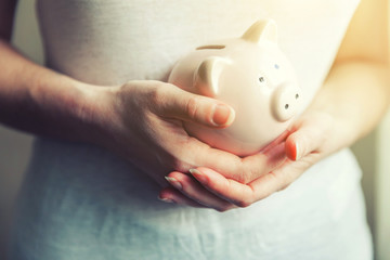 Female woman hands holding pink piggy bank. Saving investment budget business wealth retirement...