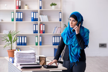 Female employee in hijab working in the office