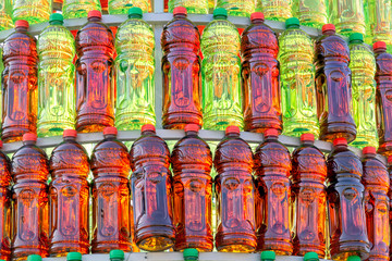 Group of plastic bottles of red and green color lined up in a pyramid