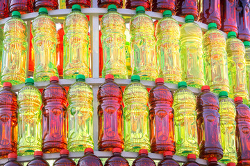 Group of plastic bottles of red and green color lined up in a pyramid