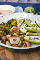 Baked, roasted vegetables on frying pan skillet. Potato, zucchini, potato with spices