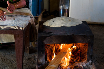 Close up of old Arab woman hands kneading fresh dough for Taboon bread or Lafah is a Middle Eastern  flatbread also called lafa or Iraqi pita.  