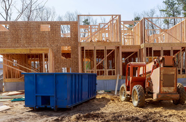 Blu dumpster, recycle waste and garbage bins near new construction site of appartment houses...
