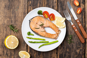 Salmon Grilled on a white plate on wooden table
