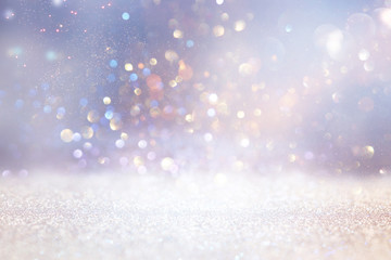 abstract glitter silver and gold lights background. de-focused