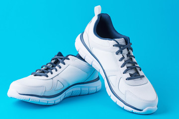 Fashion male sport shoes on a blue background. Stylish man sneakers for fitness, close up