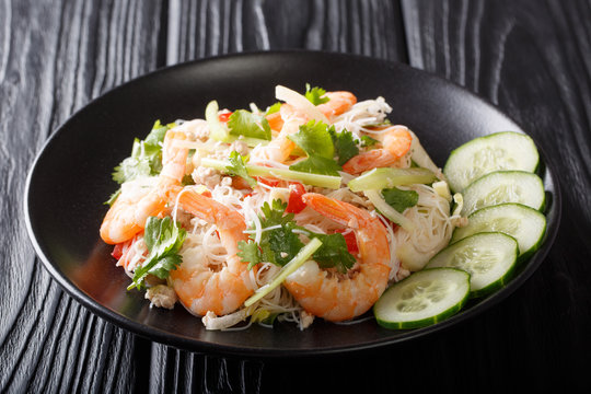 Thai recipe Yum Woon Sen salad with shrimp, pork and vegetables closeup on a plate. horizontal