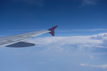 Fototapeta na wymiar Airplane wing blue sky background
