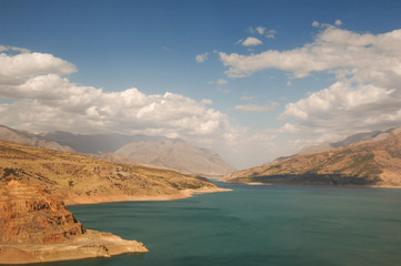 landscape with lake and mountain views. Uzbekistan, Charvak reservoir. Nature of Central Asia