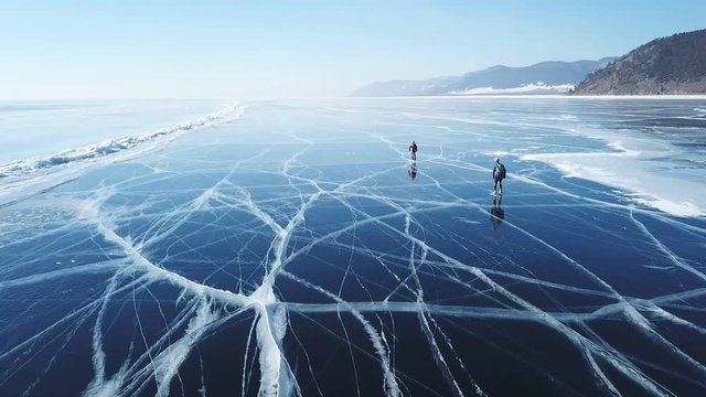 Aerial view of two ice skaters on frozen lake, Russia