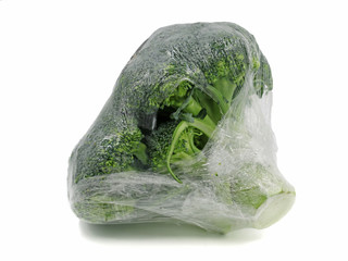 Broccoli wrapped in plastic foil isolated on white background