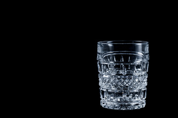 Faceted vintage glass on a black background, isolate .